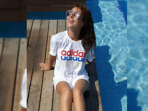 Myriam Fares posted a picture of herself sitting near the pool Source myriamfares Instagram