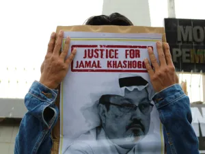 Humanitarian activists hold a poster with a picture of Jamal Khashoggi  (Shutterstock)	