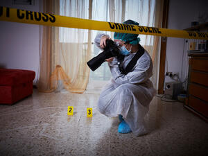 Forensics researcher photographing a blood at a murder scene. (Shutterstock/ File Photo)