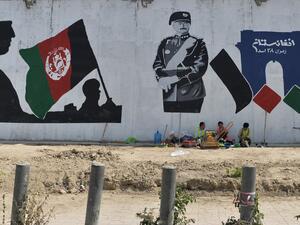 Workers take rest next to a mural of late king of Afghanistan Aman Ullah Khan, who led the successful war for Afghanistan's independence from British Rule in 1919, the day after Afghanistan held presidential elections, in Kabul on September 29, 2019. (AFP/ File Photo)