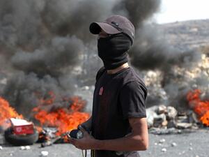 A Palestinian protester watches during clashes with Israeli security forces at the entrance of the West Bank city of Ramallah close to the Jewish settlement of Beit El, following a demonstration to show solidarity with Palestinian prisoners held in Israeli jails on October 1, 2019. (ABBAS MOMANI / AFP)