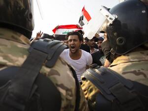 An Iraqi protestor gestures in front of security forces during a demonstration against state corruption, failing public services and unemployment, on October 2, 2019 in the southern city of Basra. (AFP/ File Photo)