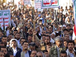 Supporters of Yemen's Shiite Huthi rebels chant slogans and raise Kalashnikov assault rifles and signs showing the group's flag, reading in Arabic "God is Great, death to America, death to Israel, curse upon the Jews, victory to Islam", as they gather for a rally in support of the group in the Huthi-held capital Sanaa on October 4, 2019. (MOHAMMED HUWAIS / AFP)