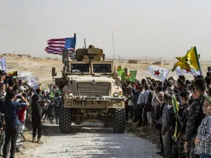 Syrian Kurds gather around a US armoured vehicle during a demonstration against Turkish threats next to a US-led international coalition base on the outskirts of Ras al-Ain town in Syria's Hasakeh province near the Turkish border on October 6, 2019. (AFP/ File Photo)