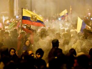 Indigenous people celebrate outside the Casa de la Cultura in Quito on October 13, 2019 after Ecuador's president and indigenous leaders reached an agreement to end violent protests. Luis ROBAYO / AFP