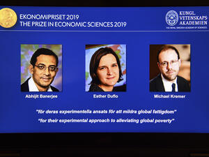 A computer screen displays the co-winners of the 2019 Sveriges Riksbank Prize in Economic Sciences in Memory of Alfred Nobel (L-R) Abhijit Banerjee, Esther Duflo and Michael Kremer during a press conference at the Royal Swedish Academy of Sciences in Stockholm, Sweden, on October 14, 2019. (AFP/ File Photo)