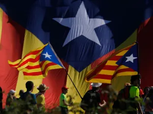 Protesters hold Catalan pro-independence "Estelada" flag as they walk on the AP-7 highway near Girona, on October 16, 2019, a day after police arrested 51 people across Catalonia overnight after violent protests over the jailing of nine separatist leaders for their role in a failed 2017 independence bid. (Pau Barrena / AFP)