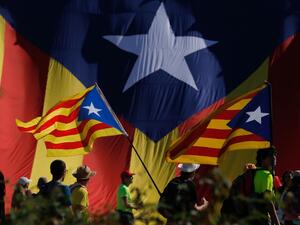 Protesters hold Catalan pro-independence "Estelada" flag as they walk on the AP-7 highway near Girona, on October 16, 2019, a day after police arrested 51 people across Catalonia overnight after violent protests over the jailing of nine separatist leaders for their role in a failed 2017 independence bid. (Pau Barrena / AFP)