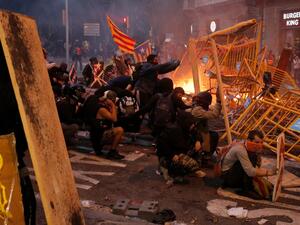 Protesters use fences as a barricade during clashes near the Police headquarters in Barcelona, on October 18, 2019, on the day that separatists have called a general strike and a mass rally. Pau Barrena / AFP