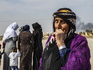 Mourners attend the funeral of civilians and fighters, who died during attacks by Turkish-led forces on the border town of Ras al-Ain, in a cemetary in Tal Tamr, near the Syrian Kurdish town of Ras al-Ain (AFP)