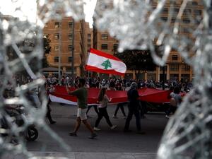 Lebanese demonstrators waving a national flag as they take part in a protest in the capital Beirut's the downtown district (AFP)