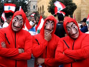 Lebanese men wearing outfits from Netflix TV series La Casa de Papelas take part in a rally in downtown Beirut on the fourth day of demonstrations against tax increases and official corruption, on October 20, 2019. (AFP/ File Photo)