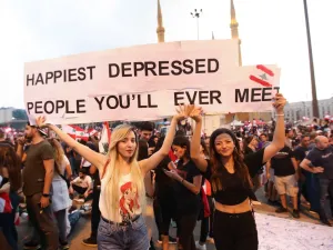 Lebanese demonstrators carry a placard as they take part in a rally in the capital Beirut's downtown district on October 20, 2019. (AFP/ File Photo)