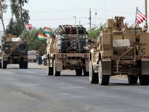 A convoy of US military vehicles arrives near the Iraqi Kurdish town of Bardarash in the Dohuk governorate after withdrawing from northern Syria on October 21, 2019. SAFIN HAMED / AFP