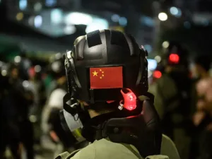 A Chinese flag is displayed on the back of the helmet of a riot police officer during a pro-democracy demonstrator in Yuen Long district of Hong Kong (AFP)