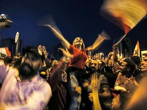 Lebanese protesters wave national flags as they attend a demonstration on the sixth day of protest against tax increases and official corruption, at Nur Square in Lebanon's northern port city of Tripoli (AFP)