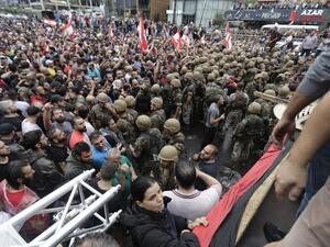 Lebanese protesters stand facing army soldiers after they deployed on main roads to remove road blocks set up by demonstrators on October 23, 2019, in the area of Zouk Mosbeh north of the capital Beirut.  (AFP/ File Photo)
