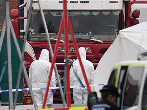 British Police forensic officers work by a lorry, believed to have originated from Bulgaria, and containing 39 dead bodies, discovered at Waterglade Industrial Park in Grays, east of London, on October 23, 2019.  (AFP/ File Photo)