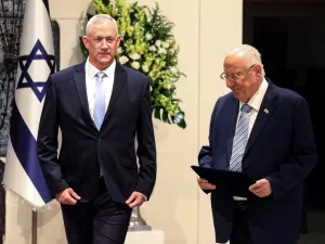 Retired Israeli general Benny Gantz (L) walks alongside President Reuven Rivlin (R) after being tasked with forming a new government, at the presidential compound in Jerusalem (AFP)