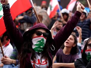 Lebanese protesters chant anti-government slogans during a broadcast by their president, in the town of Jal al Dib, northeast of Beirut, on October 24, 2019 as demonstrations to demand better living conditions and the ouster of a cast of politicians who have monopolised power and influence for decades continue. Lebanon's President Michel Aoun broke his silence after a week of unprecedented protests and expressed willingness to meet the demonstrators. "I am ready to meet your representatives... to hear your 
