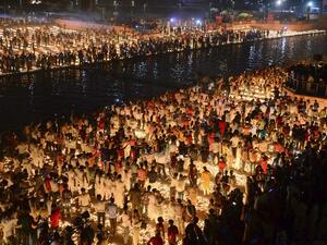 Hindu devotees light earthen lamps on the banks of the River Sarayu on the eve of "Diwali" festival during an event organised by the Uttar Pradesh government, in Ayodhya on October 26, 2019. "Diwali", the Festival of Lights, marks victory over evil and commemorates the time when Hindu god Lord Rama achieved victory over Ravana and returned to his kingdom Ayodhya. SANJAY KANOJIA / AFP
