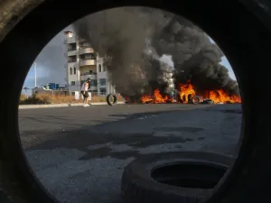 Lebanese protesters block a road with burning tires during ongoing anti-government demonstrations in the southern coastal city of Saida (Sidon) on October 28, 2019. Lebanese demonstrators set up barricades and parked cars across key roads today to protest corruption and press their demands for a radical overhaul of their country's sectarian political system. Defying pleas from Lebanon's top leaders, protesters sought to keep the country on lockdown by cutting off some of the main thoroughfares, including th
