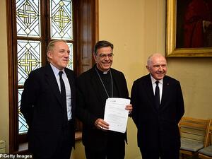 Francois Pinault, along with his son Francois-Henri Pinault (left and right) officially signed documents setting aside 100 million euros ($109 million) to reconstruct the flame-ravaged building. (AFP/ File Photo)