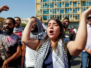 Lebanese protesters chants slogans during a demonstration in central Beirut's Martyr Square on October 6, 2019. Lebanese protested in the capital over increasingly difficult living conditions, amid fears of a dollar shortage and possible price hikes. (AFP)