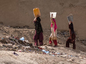 Women carrying water in Kabul, Afghanistan . (Shutterstock/ File Photo)