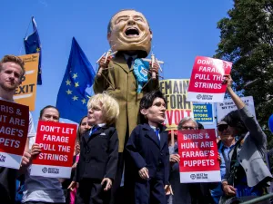 Anti Brexit protest. Stilts walker impersonating Nigel Farage holding puppets of Boris Johnson of Jeremy Hunt. (Shutterstock/ File Photo)