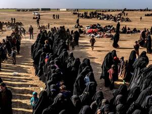 Civilians evacuated from ISIS's embattled holdout of Baghouz wait at a screening area held by the US-backed Kurdish-led Syrian Democratic Forces (SDF). (AFP/ File Photo)
