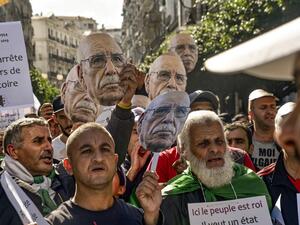 Demonstrators converged on Algiers in their thousands for a massive anti-government rally called to coincide with official celebrations of the anniversary of the war that won Algeria's independence from France. RYAD KRAMDI / AFP