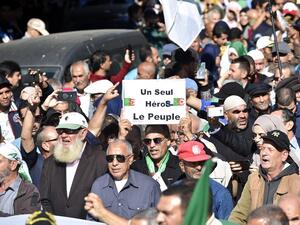 Algerians march through the streets of central Algiers as anti-government demonstrations continue on November 5, 2019. French slogan on placard reads: "One hero only, the People." (AFP/ File Photo)