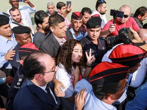 Hiba al-Labadi, a Jordanian national who was held by Israel for several months, flashes the victory gesture upon her release at the King Hussein Bridge (also known as Allenby Bridge) crossing between Israel and Jordan on November 6, 2019. (AFP/ File Photo)