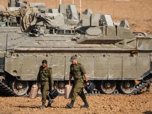 Israeli soldiers walk next to armoured vehicles near the border with the Gaza Strip on November 13, 2019. Israel launched deadly strikes against commanders of Palestinian militant group Islamic Jihad triggering a wave of tit-for-tat rocket salvos and air strikes that have killed 16 Palestinians in two days. (Menahem KAHANA / AFP)