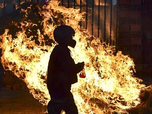 A man walks in front a fire blockade set by supporters of Bolivian ex-President Evo Morales in the outskirts of Sacaba, Chapare province, Cochabamba, on November 18, 2019. Bolivia's interim president said Sunday she will call new elections soon, as the country struggles with violent unrest a week after the resignation of Evo Morales. (RONALDO SCHEMIDT / AFP)