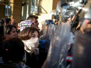 Lebanese anti-government protesters face security forces during a demonstration near the parliament headquarters in the capital Beirut's downtown district on November 19, 2019. Lebanon's parliament, besieged by protesters, said it had indefinitely postponed a session that had been due to discuss controversial draft laws. "The session has been postponed to a date to be determined later," said parliament official Adnane Daher, reading a statement in front of television cameras, citing "exceptional conditions,