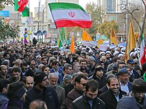 Iranians wave a national flag (R) during a protest in support of the Islamic republic's government and supreme leader, Ayatollah Ali Khamenei, in the northwestern city of Ardabil on November 20, 2019 (AFP/ File Photo)