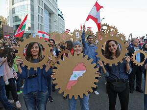 Lebanese demonstrators take part in a civilian Independence Day parade in Beirut's Martyr Square on November 22, 2019, more than a month into protests demanding an overhaul of the entire political system. (AFP/ File Photo)
