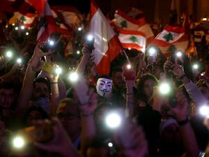 Lebanese demonstrators take part in a civilian Independence Day parade in Beirut's Martyr Square on November 22, 2019, more than a month into protests demanding an overhaul of the entire political system. Lebanese celebrated 76 years of national self-rule Friday, tens of thousands massing for joyous street festivities rather than stiff military parades to hail what a new protest movement calls "real independence". Patrick BAZ / AFP