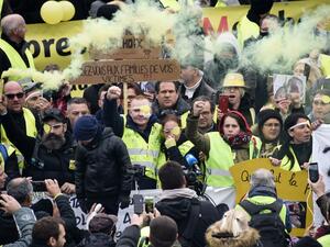 Manuel C., a "Yellow Vest" who was wounded in his left eye by a projectile likely shot by police during a "yellow vest" (gilets jaunes) demonstration on November 16, takes part alongside his wife, one of the movement's leading figures Jerome Rodrigues (3rd L) and other protesters in a march against police violence, on November 23, 2019, in the streets of Valenciennes, northern France. (AFP/ File Photo)