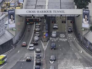 Commuters drive through the reopened Cross Harbour Tunnel, a key route between the Kowloon peninsula, in Hong Kong early on November 27, 2019, after protesters stationed in and around the Hong Kong Polytechnic University closed the link on November 13. (Anthony WALLACE / AFP)
