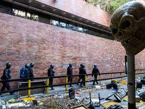Hong Kong Police Explosive Ordnance Disposal Bureau (EOD) personnel search for explosives and chemicals at the Hong Kong Polytechnic University in the Hung Hom district of Hong Kong on November 28, 2019, over a week after police surrounded the building while pro-democracy protesters were still barricaded inside. ANTHONY WALLACE / AFP