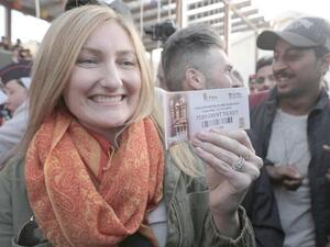 Alison Carey, from California, displays her permanent pass to Petra after becoming the millionth visitor to the ancient city this year on Thursday (Petra photo)