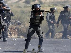 An Israeli border guard takes aim during clashes with Palestinian demonstrators in the West Bank in 2017. (AFP)
