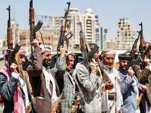 Houthi rebels hold up Kalashikov assault rifles at meeting in capital Sanaa on Saturday (AFP)