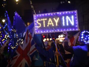 Anti-Brexit protesters with signs and EU flags lit up with fairy lights demonstrate outside the Houses of Parliament in London on September 9, 2019 as MPs debate. (AFP/ File Photo)