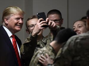 US President Donald Trump poses for selfies during a Thanksgiving dinner with US troops at Bagram Air Field during a surprise visit on November 28, 2019 in Afghanistan. Olivier Douliery / AFP