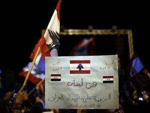 A Lebanese anti-government protester holds a placard readingin Arabic “From Lebanon to Iraq”, during a rally in the capital Beirut's downtown district on November 30, 2019. More than a month into unprecedented anti-government protests, Lebanon is facing a dual political and economic crisis. Patrick BAZ / AFP