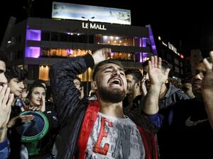 Protesters chant slogans and strike a tabla during an anti-government demonstration in the southern Lebanese city of Sidon on December 1, 2019. Mahmoud ZAYYAT / AFP